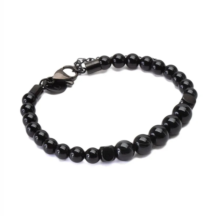 A black beaded bracelet featuring natural stone beads and a sleek metal clasp. Enjoy the elegance of black agate in this exquisite accessory.