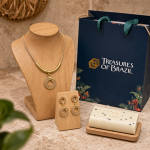 Mandala necklace and matching earrings displayed on natural wood with Natura vegan soap and a Treasures of Brazil gift bag