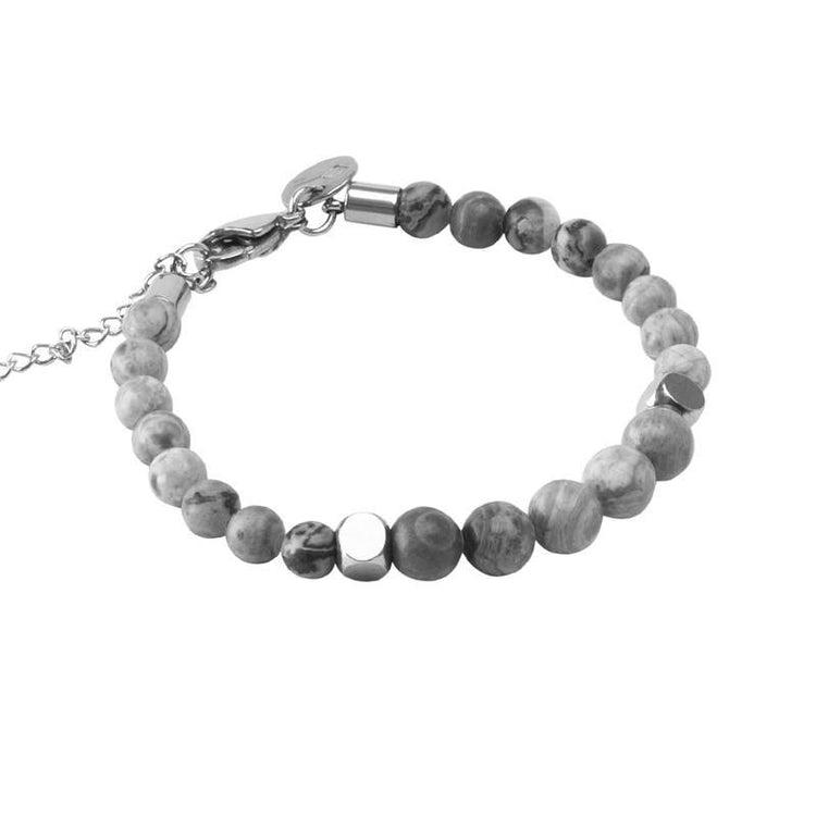 A grey beaded bracelet featuring natural stone beads and a sleek metal clasp. Enjoy the elegance of natural grey jasper stone in this exquisite accessory.