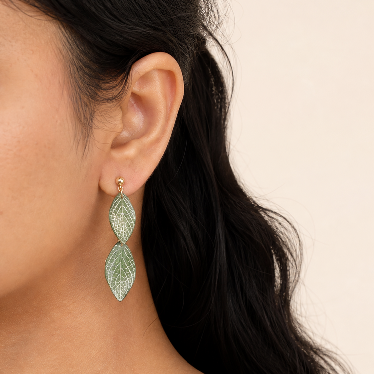 Lightweight botanical leaf drop earrings worn on the ear
