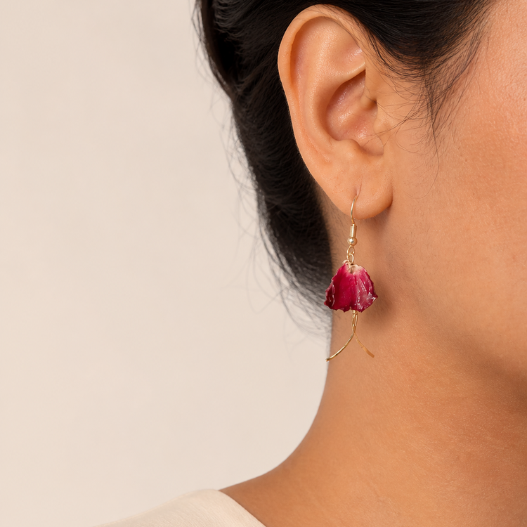 Deep red orchid stem earrings worn on the ear