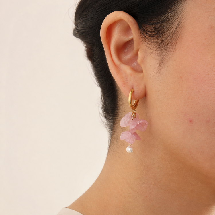 Pink hydrangea pearl hoop earrings worn on the ear