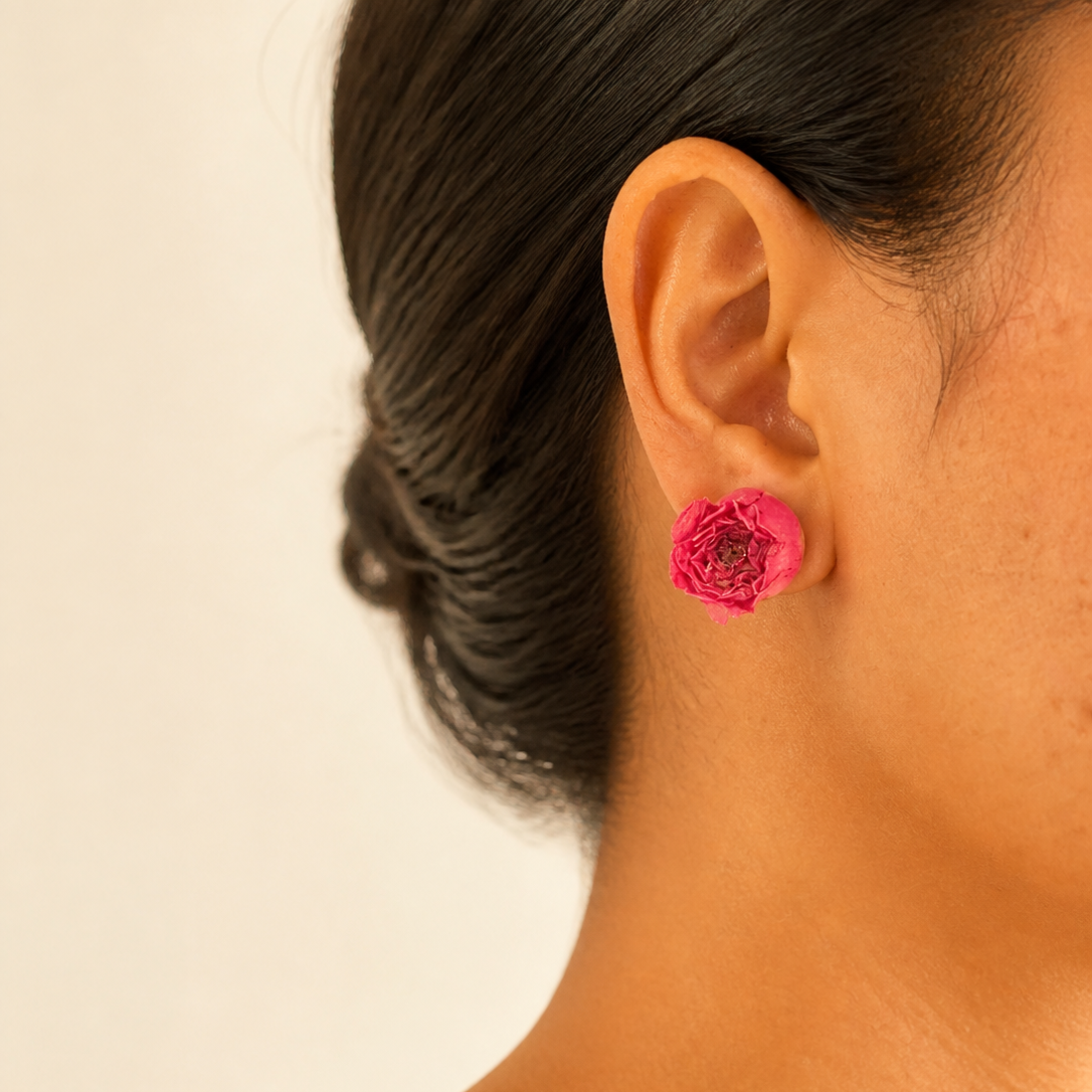 Preserved rose resin stud earrings worn on the ear