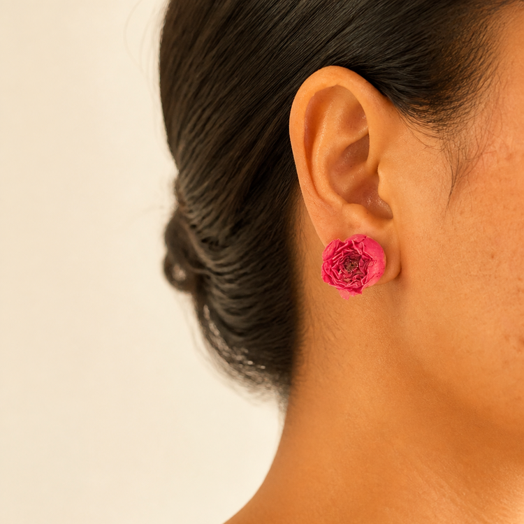 Preserved rose resin stud earrings worn on the ear