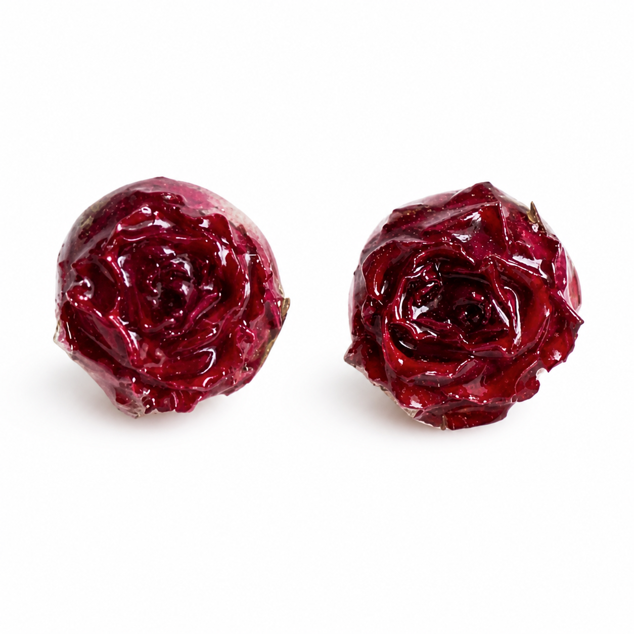 Deep red preserved rose resin stud earrings on white background