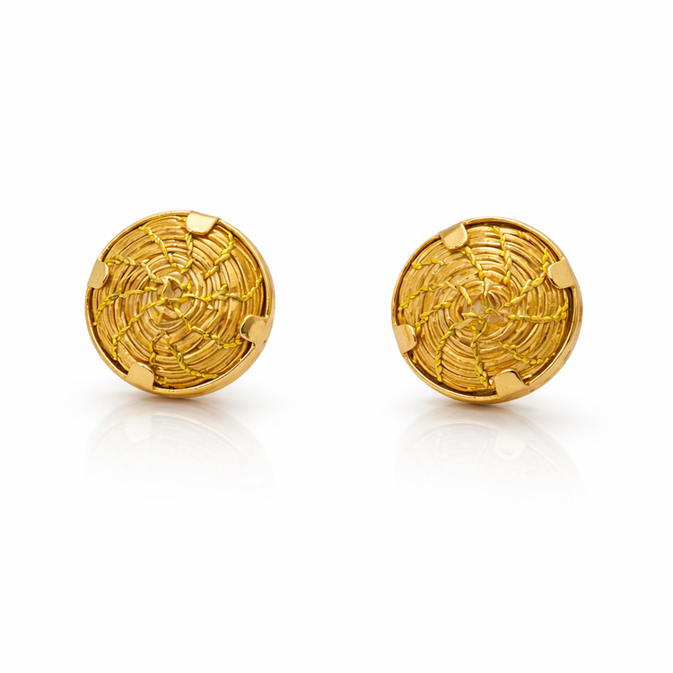 Pair of gold round earrings on a white background