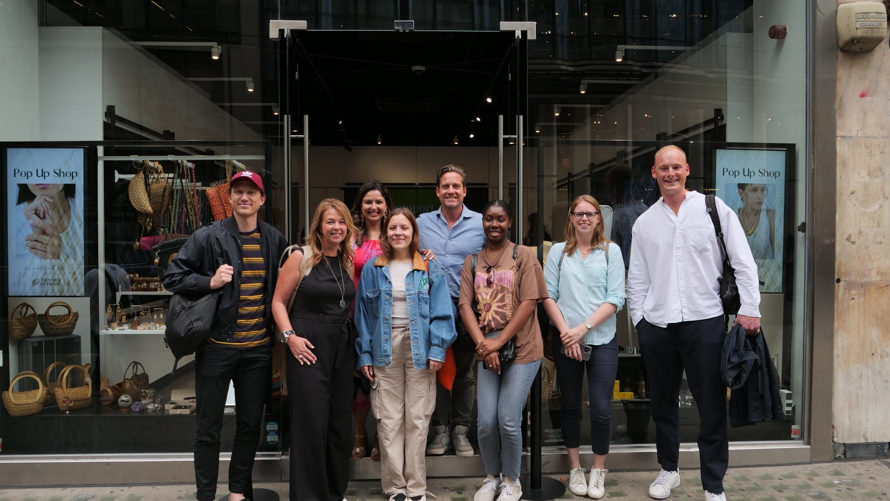Team and visitors outside a Treasures of Brazil pop-up shop in 2023
