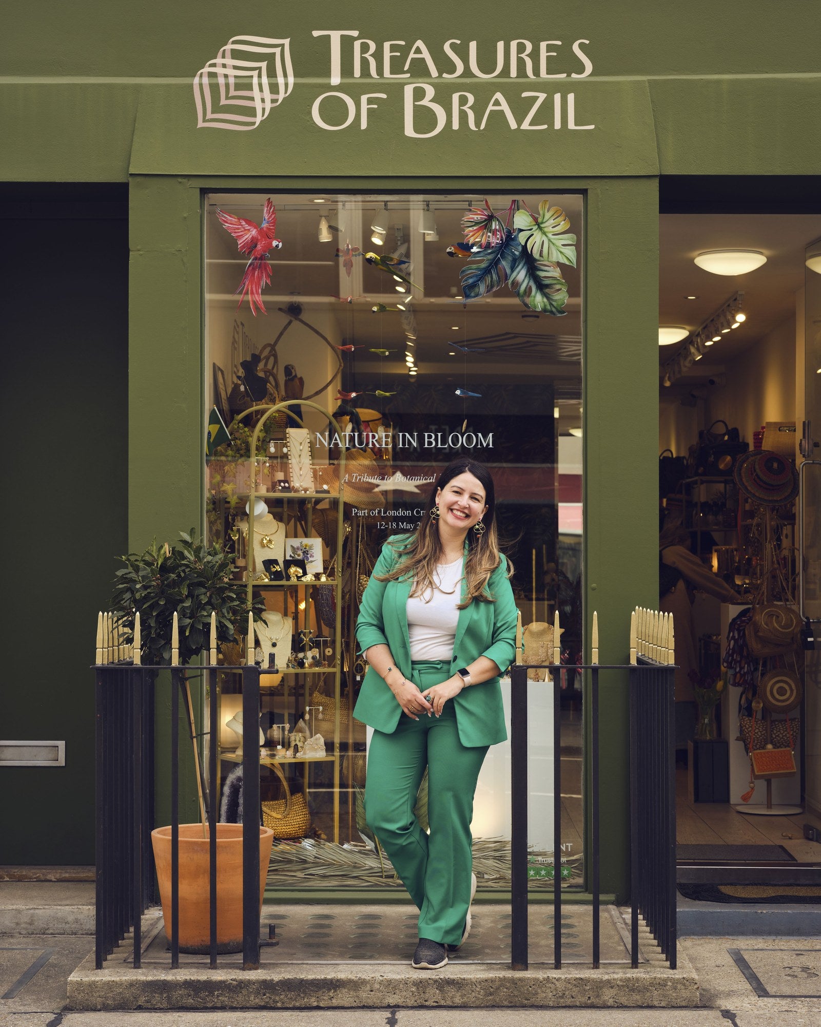 Daiane outside the green Treasures of Brazil storefront in Marylebone