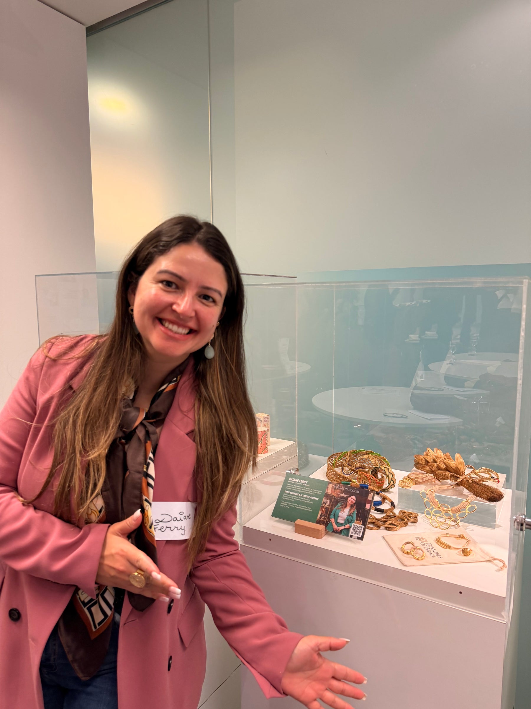 Daiane Ferry beside the Treasures of Brazil jewellery display at the British Library Business and IP Centre